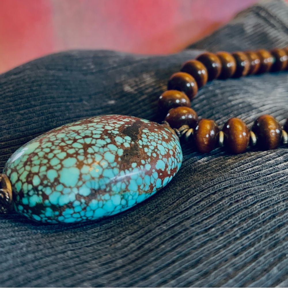 Turquoise necklace with polished wood, turquoise beads, and silver details.